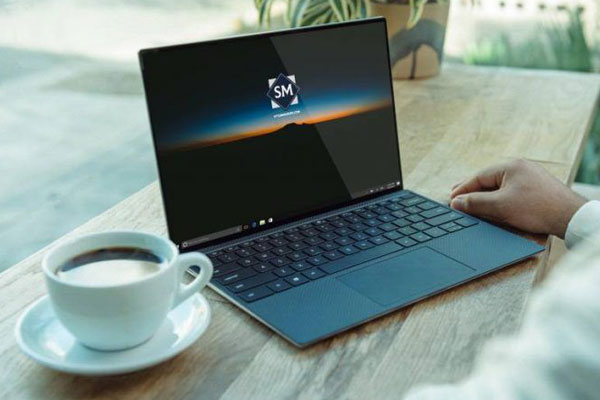 Laptop on a Table in Front of a Man Mockup FREE PSD