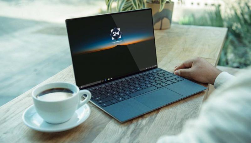 Laptop on a Table in Front of a Man Mockup FREE PSD