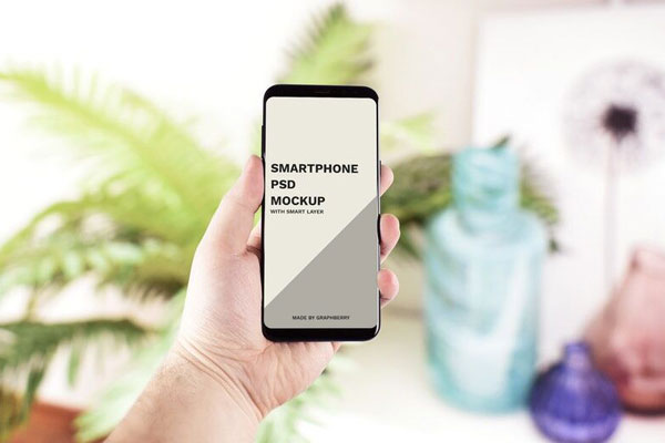 Mockup of a Front View Smartphone in Hand FREE PSD