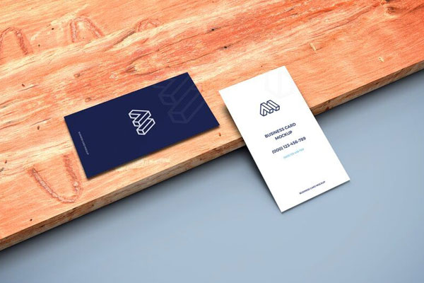 Mockup of Two Business Cards in Perspective Featuring a Wooden Board FREE PSD