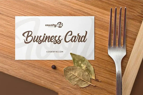 Overhead View of Business Card on Wooden Table Mockup FREE PSD