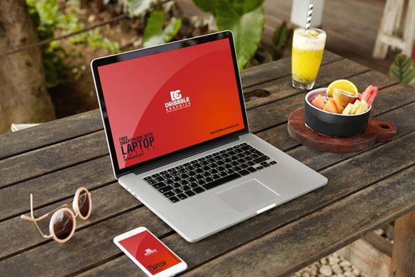 Perspective View of Smartphone and Laptop on Wooden Table Mockup FREE PSD