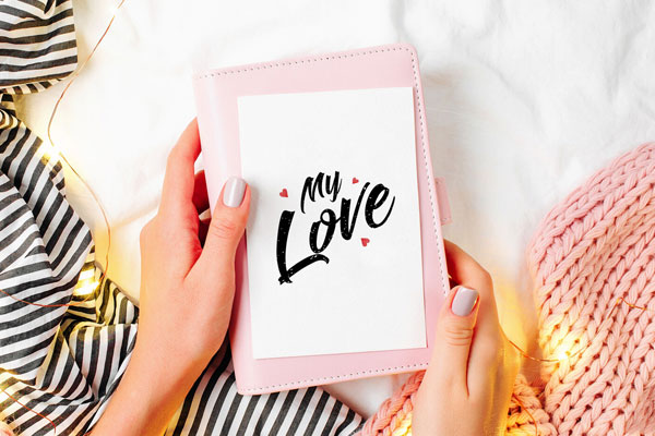 Top View of Girl Holding a Greeting Card Mockup FREE PSD