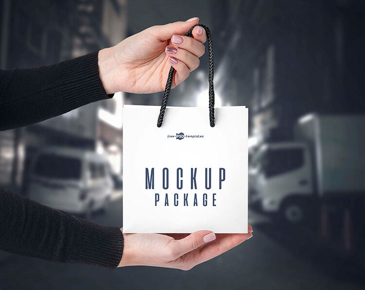 3 Front-View Mockups of a Square Paper Bag in Hand FREE PSD
