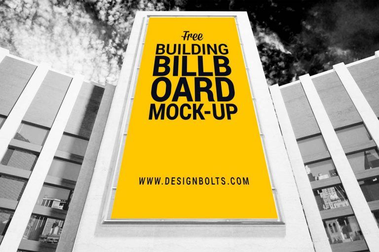 Low-Angle View Mockup of a Vertical Billboard on Building FREE PSD