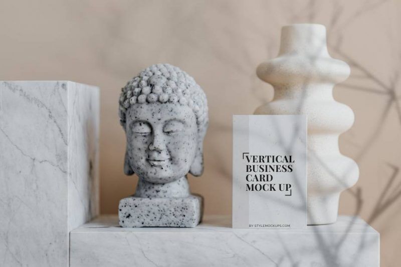 Mockup of a Vertical Business Card in Front View Featuring a Buddha Bust FREE PSD