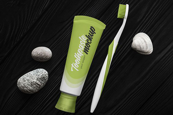 Overhead View of Toothpaste and Toothbrush on Wooden Texture Mockup FREE PSD