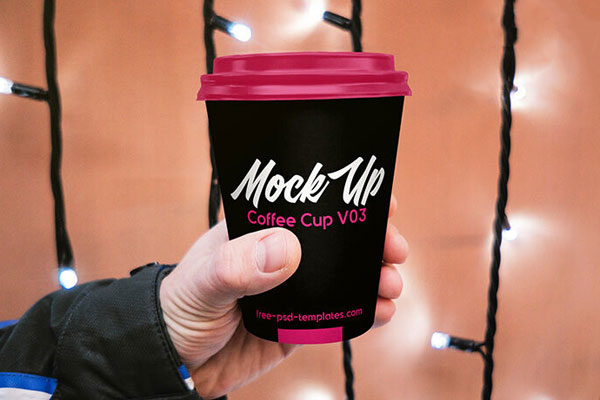 Paper Coffee Cup Held By Hand in the Front View Mockup FREE PSD