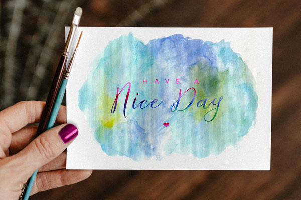 Top View of A Greeting Card With Watercolor Painting Mockup In A Woman's Hand FREE PSD