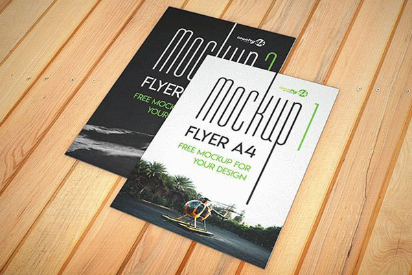 Two A4 Flyer Mockups on a Wooden Surface FREE PSD