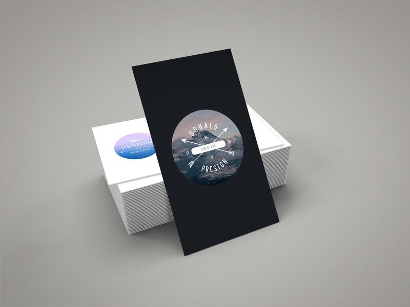 Vertical Business Card Leaning against Stack of Horizontal Cards Mockup FREE PSD