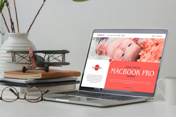 3/4 View MacBook Pro on Table Mockup with Books FREE PSD