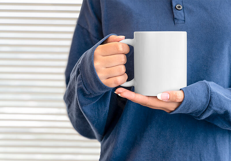 Front View of a Mug in Feminine Hands Mockup FREE PSD