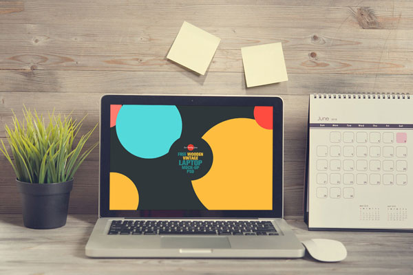 Laptop Opened on a Wooden Desk in Front View Mockup FREE PSD
