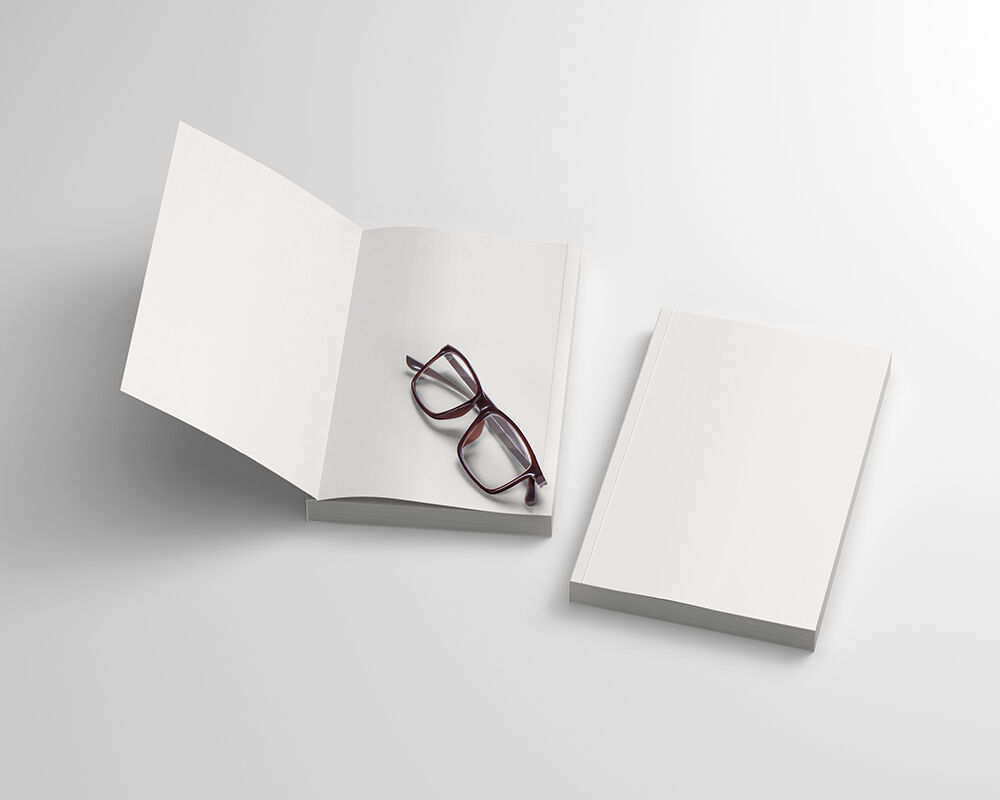Mockup Featuring Two Open and Closed Softcover Books with Glasses FREE PSD