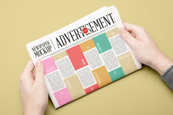Newspaper Mockup Held by Hands in Perspective FREE PSD