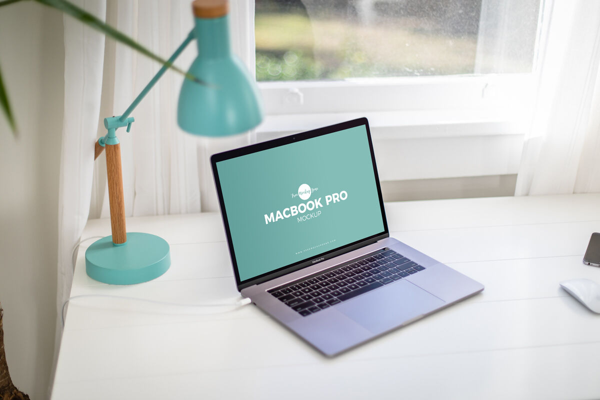 Opened Silver MacBook Pro on a Home Office Desk Mockup FREE PSD