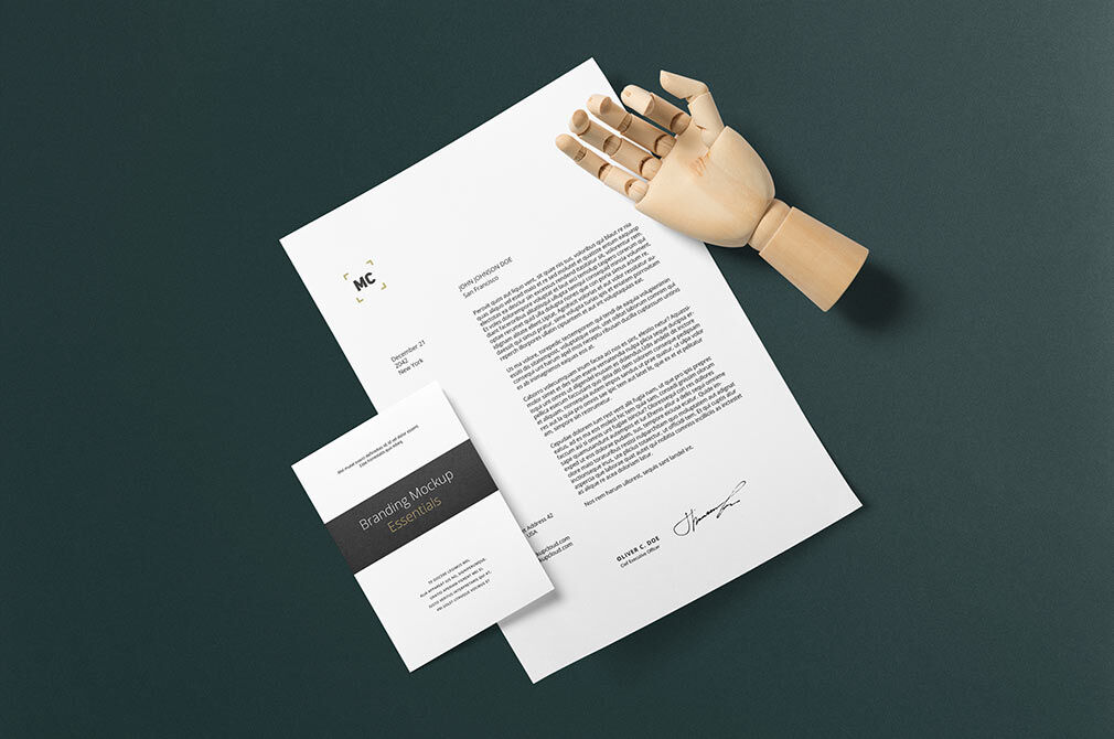 Stationery Mockup Laid in Top View Featuring an Artificial Wooden Hand FREE PSD