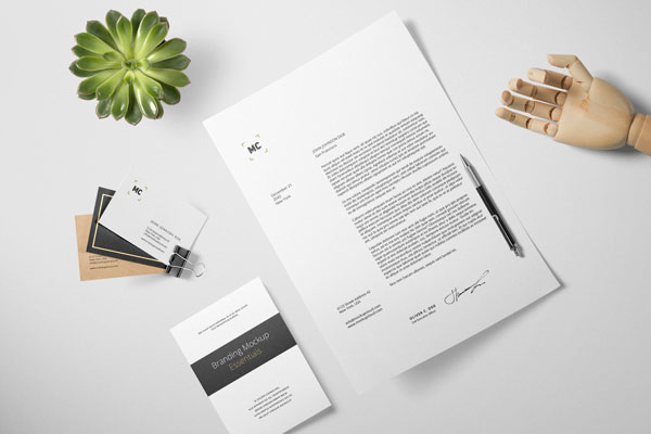 Stationery Mockup Laid in Top View Featuring an Artificial Wooden Hand FREE PSD