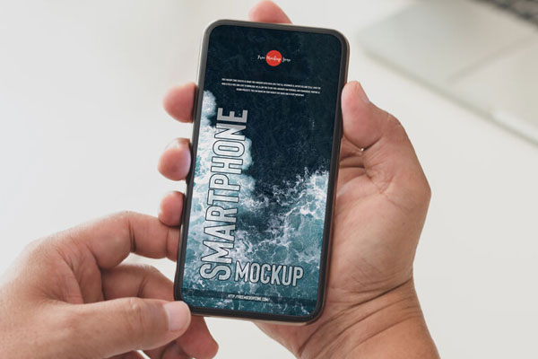 Top View of Hand Holding Smartphone Mockup FREE PSD
