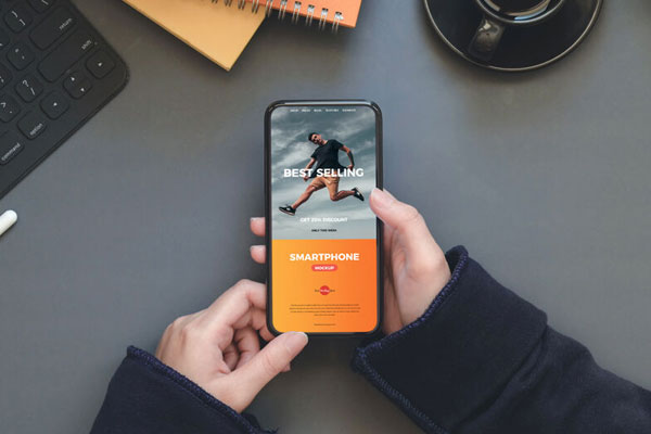 Workstation Mockup of Smartphone in a Person's Hand FREE PSD