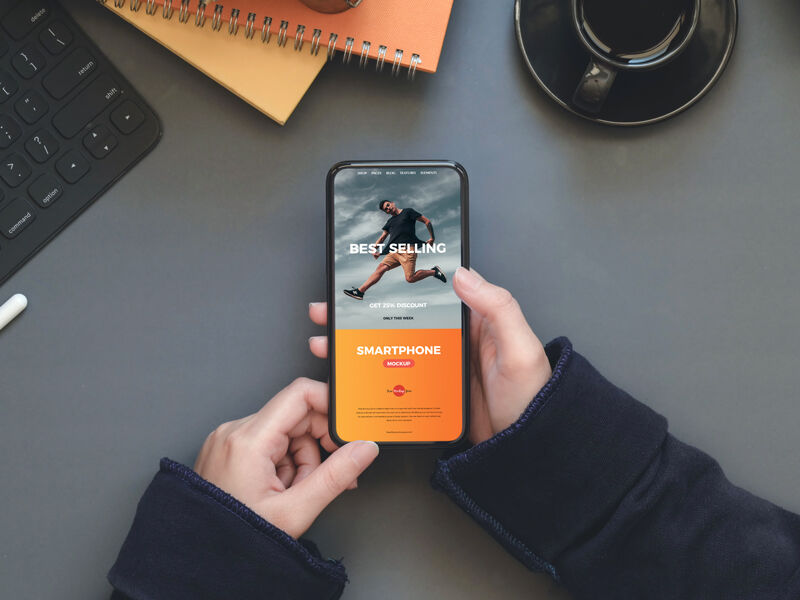 Workstation Mockup of Smartphone in a Person's Hand FREE PSD