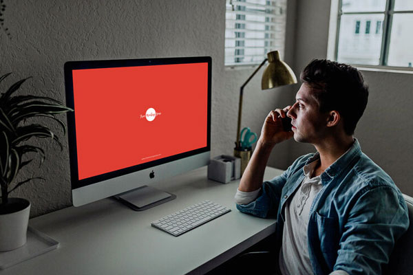 3/4 View Developer Using iMac Mockup Scene FREE PSD