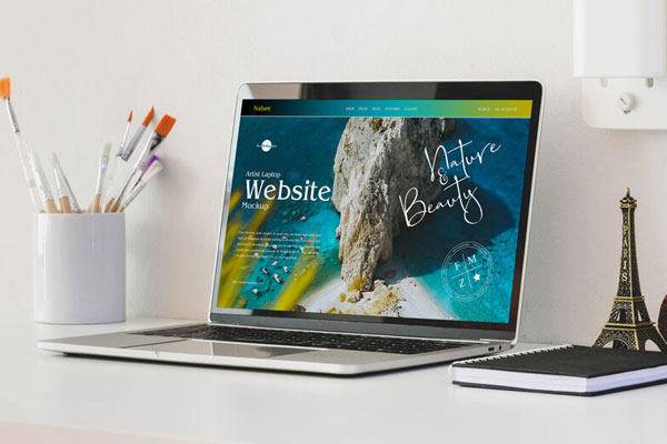 3/4 View Laptop on Table Mockup with Eiffel Tower Figurine FREE PSD