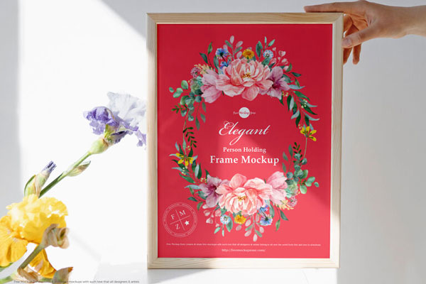 Front View Person Holding Wooden Frame with Flowers Mockup FREE PSD