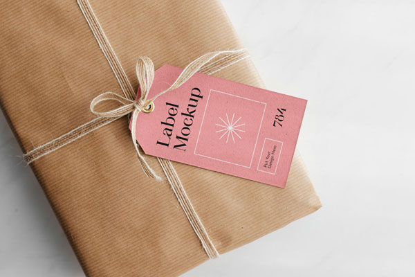Gift Card Mockup Hung From Wrapped Package in Top View FREE PSD