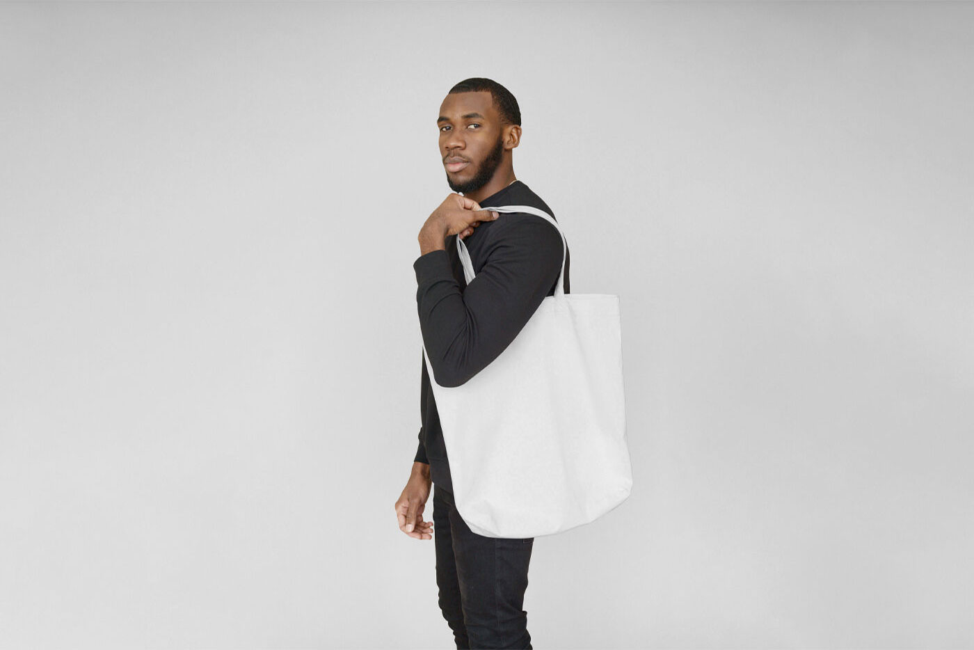 Man Carrying a Large Canvas Bag on His Shoulder Mockup FREE PSD