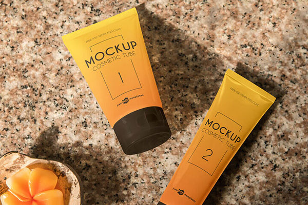 Perspective View 2 Cosmetic Tubes on Marble with Flowers Mockup FREE PSD