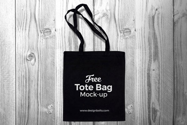 Top View Black Cotton Tote Shopping Bag on Wooden Floor Mockup FREE PSD