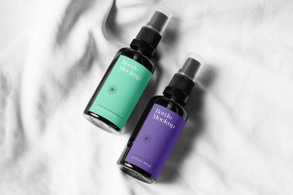 Two Small Spray Bottle on a Soft Sheet Mockup FREE PSD