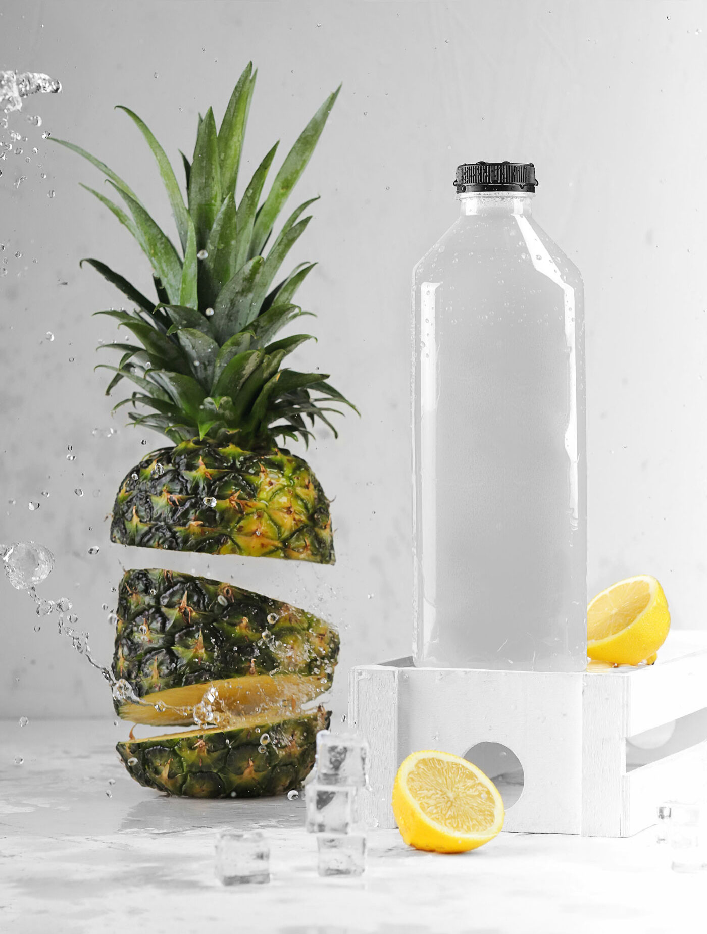 Bottle Mockup with Pineapple, Lemon, and Ice Cubes FREE PSD