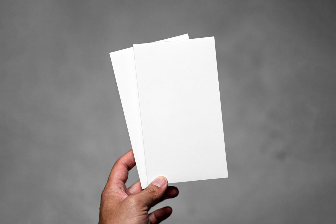 Front View of Hand Holding Vertical Leaflets Mockup FREE PSD