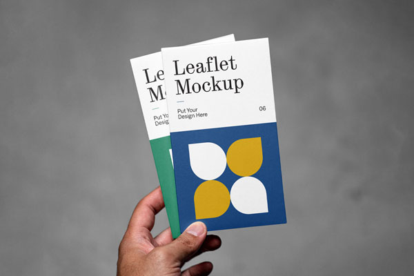 Front View of Hand Holding Vertical Leaflets Mockup FREE PSD