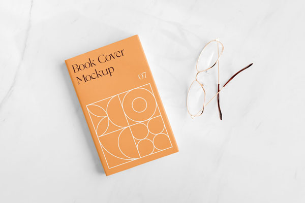 Top View of a Book Cover on Marble Surface Mockup FREE PSD
