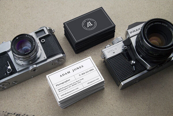 Two Business Card Mockups Next to Vintage Cameras FREE PSD