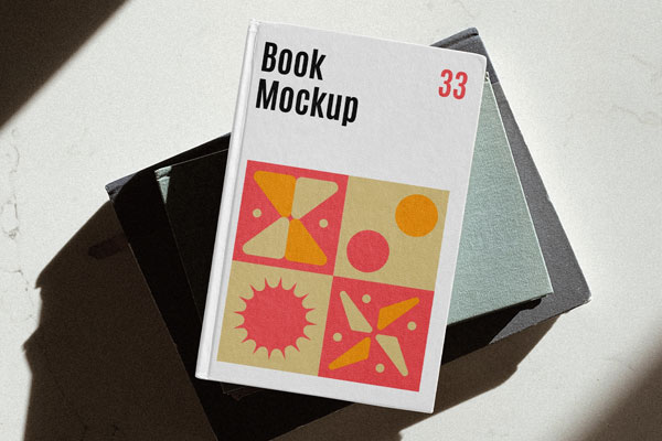 Top View of a Hardcover Book Next to a Glass Mockup FREE PSD