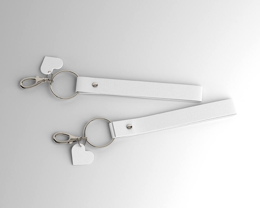 2 Leather Keyrings Laid on the Surface in Top View Mockup FREE PSD