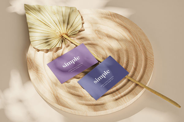 Close-up View of Three Business Card Mockups on a Wooden Ornament FREE PSD