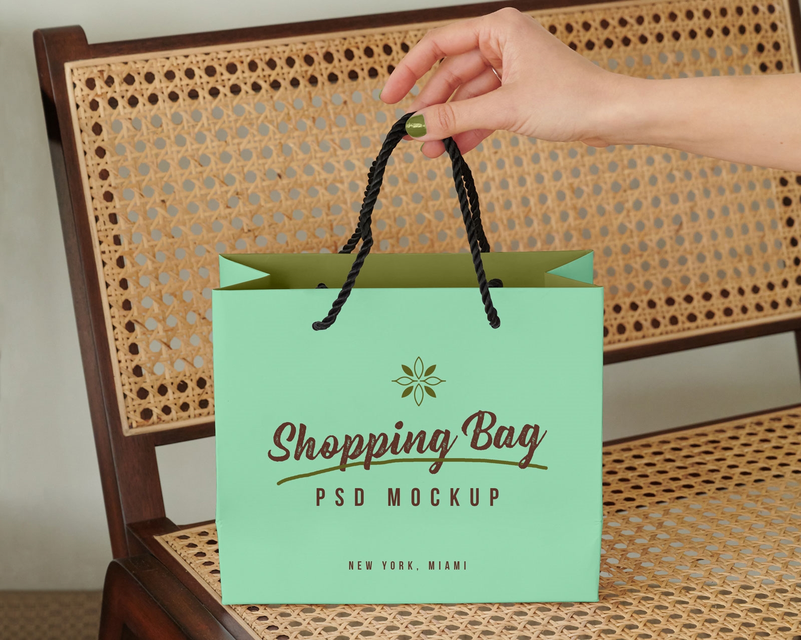 Mockup Showing a Hand Holding Shopping Bag on a Bench FREE PSD