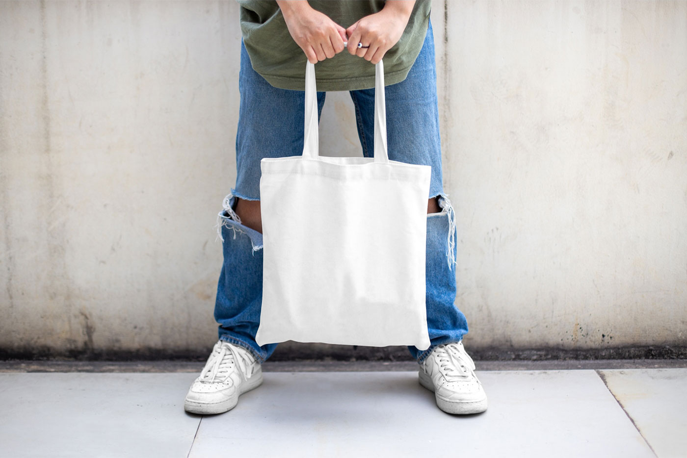 Casual Outdoor Man Holding Canvas Bag Mockup from Front View FREE PSD