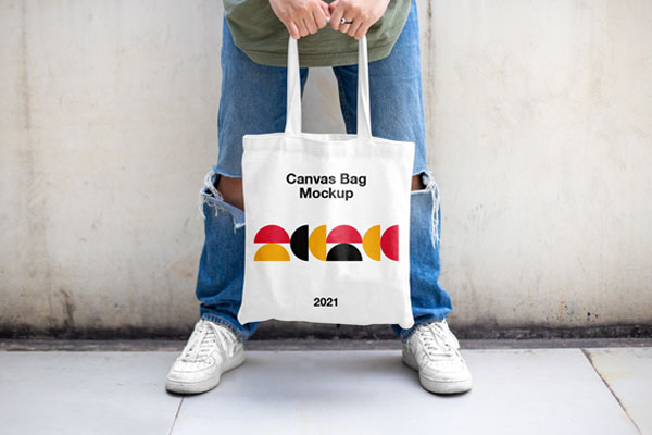 Casual Outdoor Man Holding Canvas Bag Mockup from Front View FREE PSD