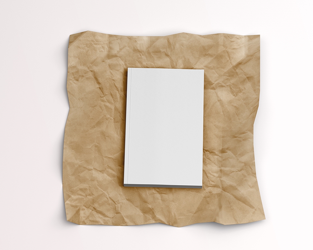 Top View of a Softcover Book on a Wrinkled Paper Mockup FREE PSD