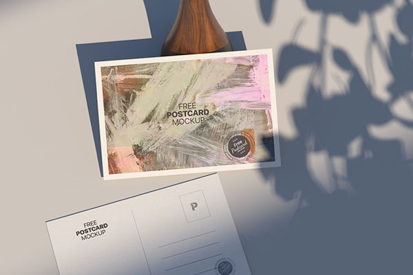 Top View of Postcard Mockup Against the Rustic Vase FREE PSD