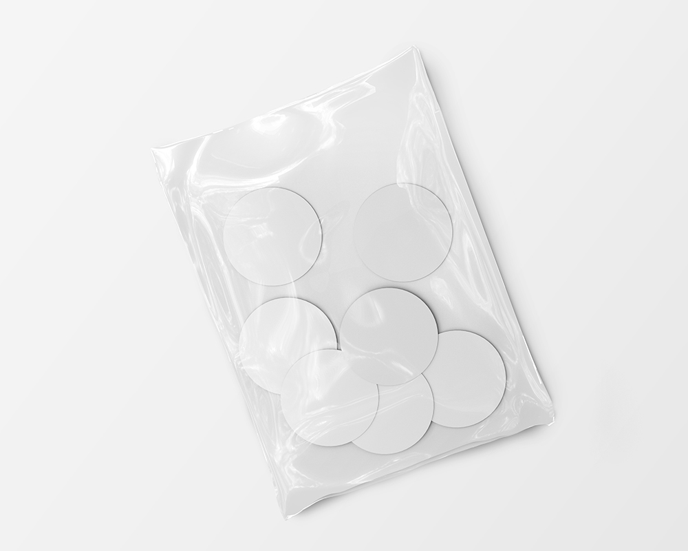 Top View of Seven Round Stickers in a Plastic Wrapping Mockup FREE PSD