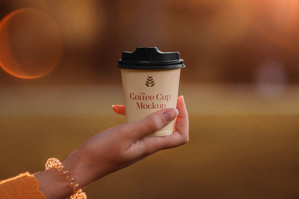 Front View of Small Woman Hand Holding Coffee Cup Mockup FREE PSD