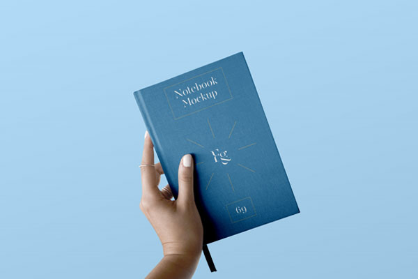 Front View of Hand Holding Notebook Cover Mockup FREE PSD